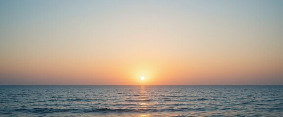 Obraz premium Serene Sunset Over Calm Ocean Waters with Soft Pastel Tones on the Horizon