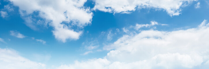 Clear blue sky with a few clouds. The sky is very bright and the clouds are scattered throughout