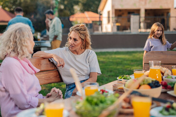 Family enjoying a healthy lunch in the garden during a reunion party