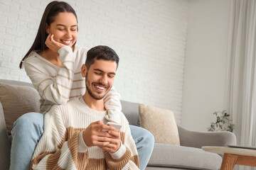 Happy young couple spending time together at home