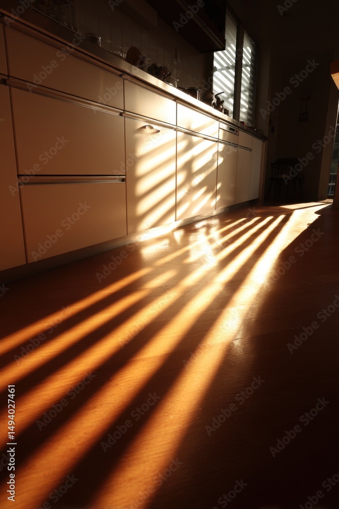 Poster sunlight through blinds in modern kitchen illuminating wood floor creating shadows and light pattern