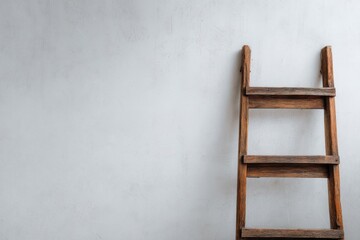 Rustic wooden ladder leaning against a textured white wall minimalist composition simple background studio shot concept of growth and aspiration