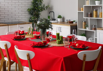 Stylish table setting for Christmas dinner in kitchen