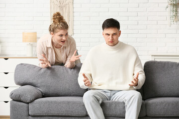 Young couple arguing in living room