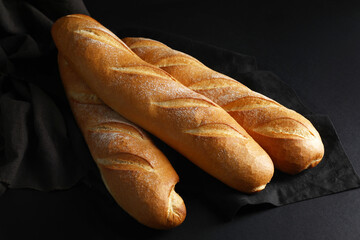 Fresh baguettes on black background