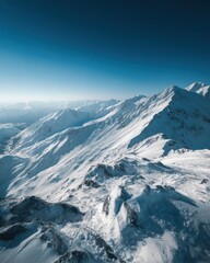 Obraz premium Aerial view of snow covered mountain range under a clear blue sky in Alaska landscape photography