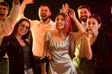 Group of young people dancing at party in night club