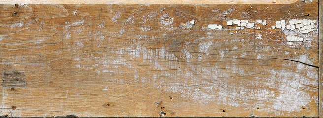 Rough sanded wood board plank or siding or wall with cracks and distressed finish