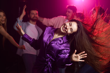 Beautiful woman dancing at party in night club
