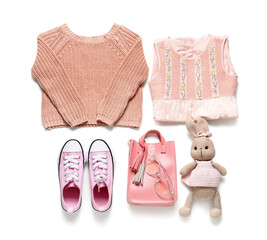 Stylish children's clothes with toy on white background