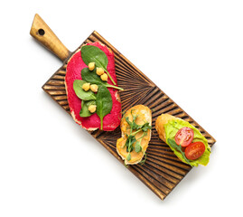 Wooden board of different sandwiches with hummus on white background
