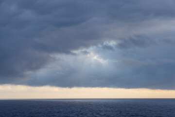 Dramatic Cloudscape Over the Calm Pacific Ocean at Sunset