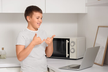 Mute boy using sign language during video call at home
