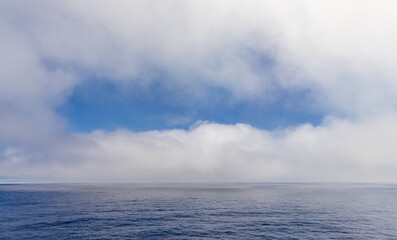 Blue Sky and Cloudscape over Calm Pacific Ocean Horizon