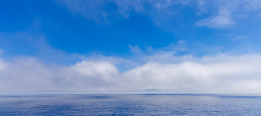 Serene Cloudscape Above the Vast Blue Waters of the Pacific Ocean