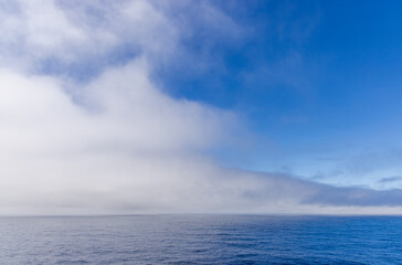 Obraz premium Dramatic Sky Above the Ocean With Clouds Over Expansive Water Horizon