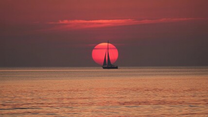 Sailboat Silhouette Against Fiery Ocean Sunset
