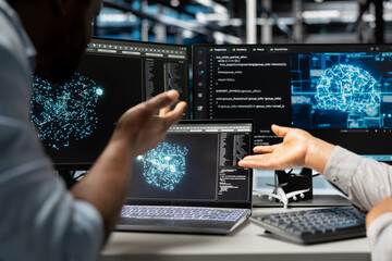 Server farm engineering team looks at data analysis graph to reduce supercomputers failure. Data center coworkers look at AI visualization dashboard to pinpoint gear performance glitches