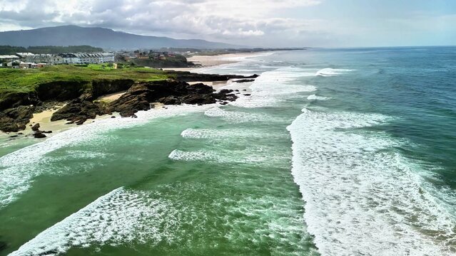 Experience the breathtaking coastal ocean view featuring crashing waves and lush green cliffs