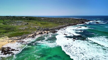 A Beautiful and Scenic Coastal Landscape Featuring Waves and Lush, Vibrant Greenery