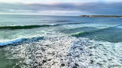 Experience the breathtaking beauty of coastal waves and the serene shoreline on your next adventure