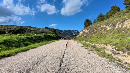 A Scenic Mountain Road Surrounded by Lush Greenery and Breathtaking Natural Beauty