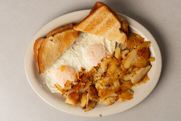 two eggs with toast and potatoes