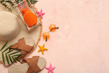 Composition with bottle of sunscreen cream and beach accessories on pink grunge background