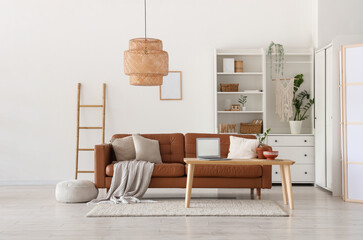 Brown sofa and wooden coffee table in interior of living room