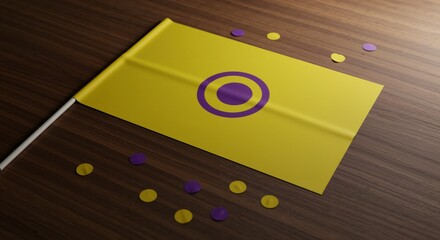 A vibrant yellow and purple intersex pride flag, featuring its distinctive purple circle emblem, lies flat on a dark wooden surface, surrounded by matching confetti.