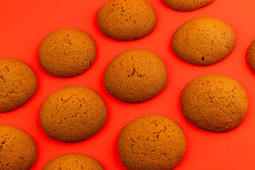 Freshly baked round cookies on vibrant red background