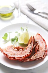 Delicious boiled lobster served on white table, closeup