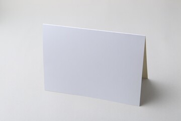 One blank greeting card on light background
