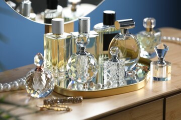Bottles of perfumes on wooden table indoors