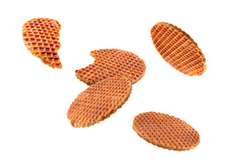 Yummy Dutch waffles (stroopwafels) flying on white background