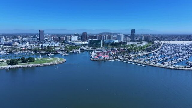 Aerial Long Beach California cargo port to city 3. Coastal city near Los Angeles. Cargo and container ship terminal for Asian and China trade. Waterfront attractions on the Pacific. Cruise ship port.