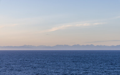 Tranquil Ocean View with Distant Mountains Under Clear Sky