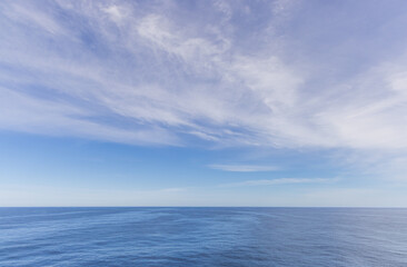 Bright Blue Ocean and Sky with White Clouds on a Sunny Day