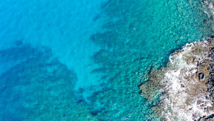 Aerial photo of coral reef in clear blue water
