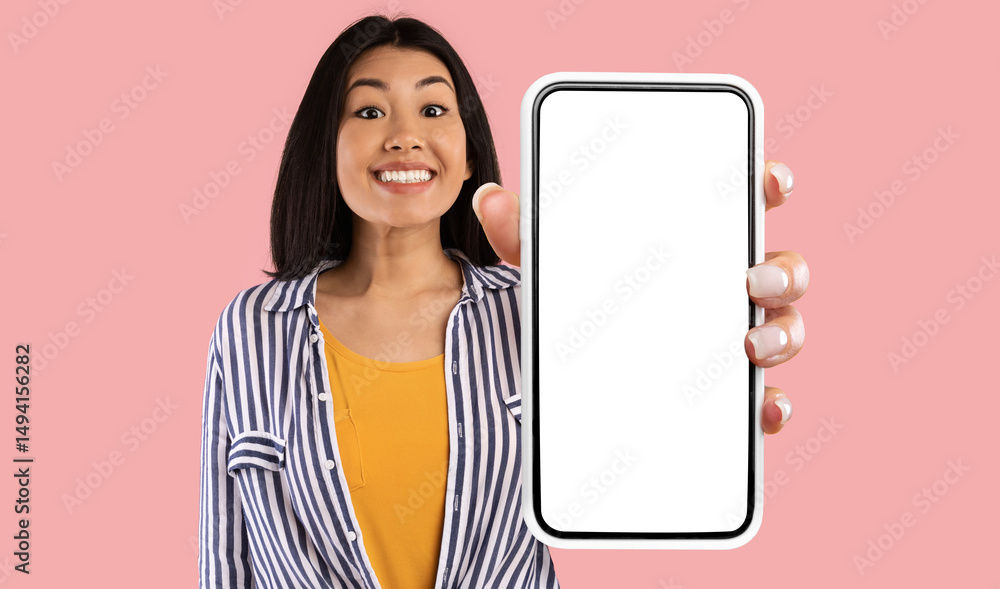 Poster great mobile offer. excited asian lady showing big smartphone with empty screen to camera advertisin
