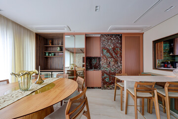 Modern dining room with wooden furniture, elegant decor, natural lighting, and contemporary interior design in a luxury apartment