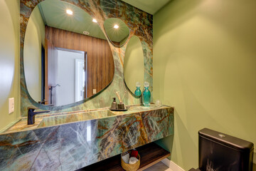 Modern and elegant bathrooms in a luxury apartment, featuring marble finishes, large mirrors, glass showers, and natural lighting