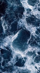 Naklejka premium Dynamic ocean waves with white foam in deep blue sea close up