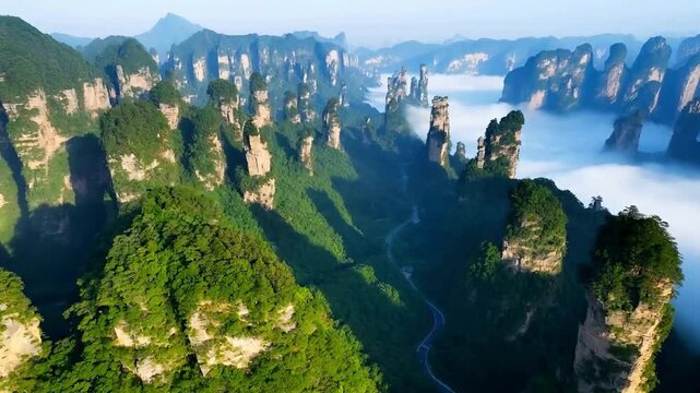 The clouds are swirling around the mountains in Zhangjiajie, China, presenting a breathtaking sight of unique peaks.
