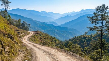 Fototapeta premium Serene Mountain Road Winding Through Lush Green Hills Under Clear Blue Sky with Majestic Mountain Range in Background