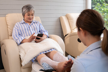 Fototapeta premium Asian female spa therapist gently massaging senior Asian woman's feet during spa session, emphasizing spa, treatments, beauty, skincare, healthcare, and salon comfort and relaxation.