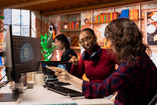 AI startup office colleagues cooperating, designing and implementing algorithms enabling machine learning. Teamworking artificial intelligence tech venture employees collaborating to fix code bugs