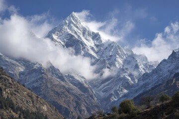 Snowy Mountain Peak With Clouds And Mist