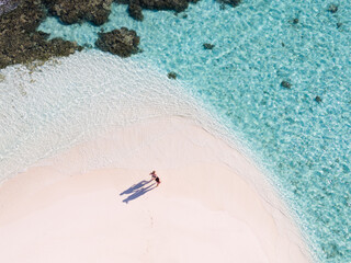 Top down aerial view of adult couple on a beach, Maldives