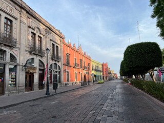 Cobblestone Street with Colonial-era buildings  Santiago de Querétaro, Mexico, that Runs Parallel to a City Park
